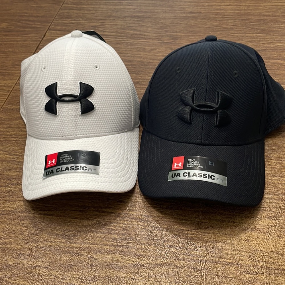 Two under armor fitted hats. Both M/L and NWT: